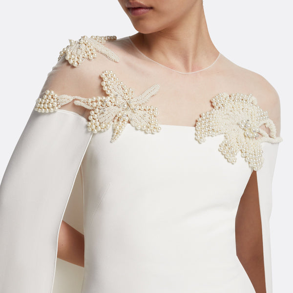 Woman in ivory wedding dress with pearl embellishment