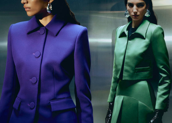 Women in purple and green tailored suits and jackets